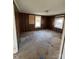 Spacious living room with wood paneling and carpeted floors at 203 N Meriah St, Landis, NC 28088