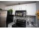 Modern kitchen features stainless steel appliances and granite countertops at 195 Edward Ave # 13, Concord, NC 28025
