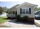 Tan house with a brick base, porch, and landscaping at 195 Edward Ave # 13, Concord, NC 28025