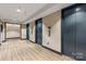 Hallway with elevators and wood flooring at 210 N Church St # 2613, Charlotte, NC 28202