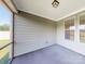 Covered screened porch with neutral walls and flooring at 7025 Stella Pl, Stanley, NC 28164