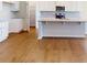 Kitchen with white cabinets, granite countertops and hardwood floors at 7025 Stella Pl, Stanley, NC 28164