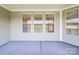 Covered porch with multiple windows and neutral walls at 7025 Stella Pl, Stanley, NC 28164