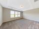 Spacious bedroom with neutral walls and carpet, featuring a large window with blinds at 7025 Stella Pl, Stanley, NC 28164