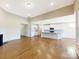 Open kitchen with white cabinets and an island at 7025 Stella Pl, Stanley, NC 28164