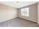 Well-lit bedroom featuring a large window and carpet at 7025 Stella Pl, Stanley, NC 28164
