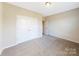 Bright bedroom with double doors and carpet flooring at 7025 Stella Pl, Stanley, NC 28164