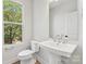 Clean and modern bathroom with a pedestal sink and large mirror at 1432 Hamilton St # 14, Charlotte, NC 28206