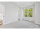 Bright bedroom with neutral walls and carpet, plus a large window at 1432 Hamilton St # 14, Charlotte, NC 28206