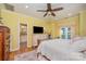 Bright bedroom with a dresser, TV, and ensuite bathroom at 10227 Mount Holly Rd, Charlotte, NC 28214
