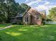 Brick house exterior with landscaped yard and screened porch at 10227 Mount Holly Rd, Charlotte, NC 28214