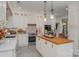 Modern kitchen with white cabinets, wood countertops and center island at 10227 Mount Holly Rd, Charlotte, NC 28214