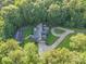 Home with circular driveway surrounded by lush trees at 10227 Mount Holly Rd, Charlotte, NC 28214