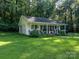 Small white cottage with covered porch and landscaping at 10227 Mount Holly Rd, Charlotte, NC 28214