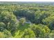 Ranch home nestled in a wooded lot with a long driveway at 10227 Mount Holly Rd, Charlotte, NC 28214