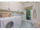 Laundry room with washer, dryer, and ample cabinet space at 10227 Mount Holly Rd, Charlotte, NC 28214
