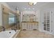 Spa-like bathroom with a large soaking tub, double vanity, and glass shower at 721 Orphanage Rd, Concord, NC 28027