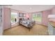 Charming bedroom with pink walls, carpeted floors, and a double bed at 198 Giant Oak Ave, Statesville, NC 28677