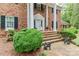 Brick home with white columns, lush landscaping, and brick pathway at 715 Saint Cloud Dr, Statesville, NC 28625