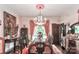 Formal dining room with chandelier, built-in shelving, and hardwood floors at 715 Saint Cloud Dr, Statesville, NC 28625