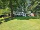 Charming ranch house with a spacious lawn and tree-lined street at 5328 Seacroft Rd, Charlotte, NC 28210