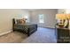 Cozy bedroom with striped bedding and a dresser at 7015 Cobblefield Ln, Denver, NC 28037