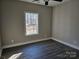 Spacious bedroom with wood-look flooring, large window, and ample natural light at 1886 Hollybrook Ln, Lancaster, SC 29720