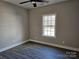 Bright bedroom with wood-look flooring and large window at 1886 Hollybrook Ln, Lancaster, SC 29720