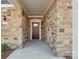 Inviting front entry with stone facade and a dark wood front door at 1346 Millview Ln, Matthews, NC 28104