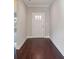 Light-filled entryway with dark hardwood floors and white door at 1346 Millview Ln, Matthews, NC 28104