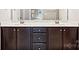Bathroom with dark brown vanity and double sinks at 1346 Millview Ln, Matthews, NC 28104