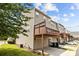 Rear view of townhome, showcasing deck, garage, and landscaping at 9341 Lenox Pointe Dr, Charlotte, NC 28273