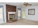 Living room with brick fireplace, ceiling fan, carpet and door to backyard at 452 Mocksville Hwy, Statesville, NC 28625