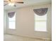 Bright bedroom with two windows, ceiling fan, and neutral carpeting at 452 Mocksville Hwy, Statesville, NC 28625
