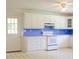 Bright kitchen with white cabinets, blue countertops, and white appliances at 452 Mocksville Hwy, Statesville, NC 28625