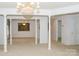 Open dining room with carpeted floor and decorative columns at 452 Mocksville Hwy, Statesville, NC 28625