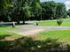 Landscaped yard with a long driveway and decorative lions at 452 Mocksville Hwy, Statesville, NC 28625
