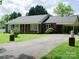 Brick ranch home with long driveway and landscaping at 452 Mocksville Hwy, Statesville, NC 28625