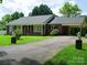 Brick ranch house with attached carport and manicured lawn at 452 Mocksville Hwy, Statesville, NC 28625