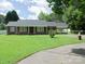 Brick ranch home with carport and manicured lawn at 452 Mocksville Hwy, Statesville, NC 28625