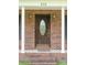 Dark stained front door with glass accents and brick columns at 452 Mocksville Hwy, Statesville, NC 28625