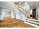 Two-story living room with hardwood floors, staircase and chandelier at 10836 Fox Hedge Rd, Matthews, NC 28105