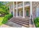 Brick porch with columns and steps leading to the front door of the home at 10836 Fox Hedge Rd, Matthews, NC 28105