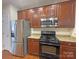 Kitchen with stainless steel appliances and granite countertops at 135 S Arcadian Way, Mooresville, NC 28117