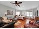 Comfortable bedroom with a sitting area, hardwood floors, and large windows at 19577 Meta Rd, Cornelius, NC 28031