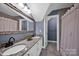 Elegant bathroom boasts dual sinks, granite countertops, and an ornate mirror at 19577 Meta Rd, Cornelius, NC 28031