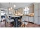 Modern kitchen with granite countertops, an island, and stainless steel appliances at 19577 Meta Rd, Cornelius, NC 28031