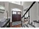 Bright and spacious entry with hardwood floors, a grand staircase, and a view to the living area at 19577 Meta Rd, Cornelius, NC 28031