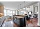 Open kitchen with a large island, breakfast nook and views into the living area at 19577 Meta Rd, Cornelius, NC 28031