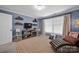 Relaxing bedroom with a TV, chaise lounge, and calming blue walls at 19577 Meta Rd, Cornelius, NC 28031
